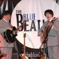 Blue beatles duo in front of backdrop